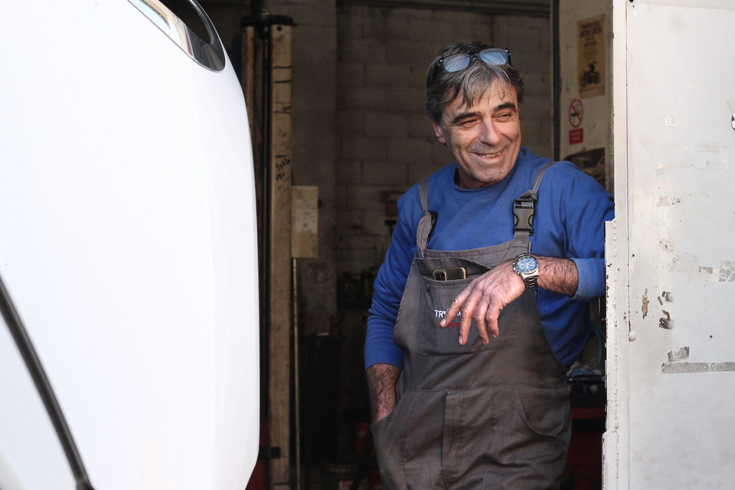 Xevi Oliver sonrient a la porta del seu taller de reparació